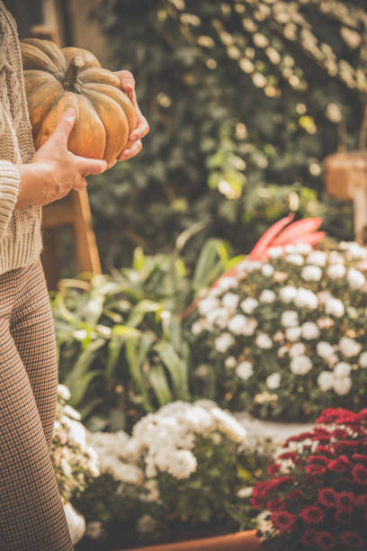 istock Woman decorating back yard in autumn 1080360030