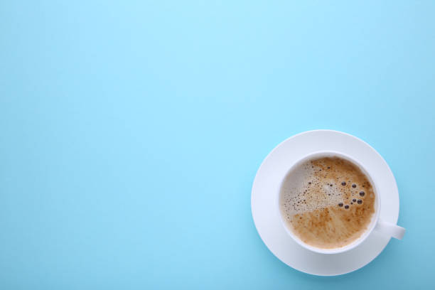 istock Cup of coffee on blue background, flat lay 1080363128