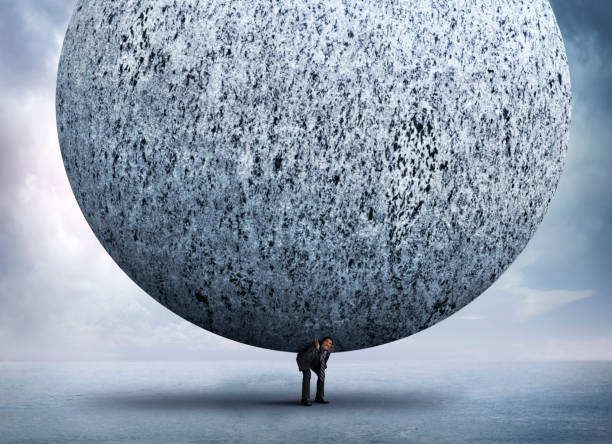 istock Businessman Bending Over To Support Very Large Stone Sphere On His Back 1080373800
