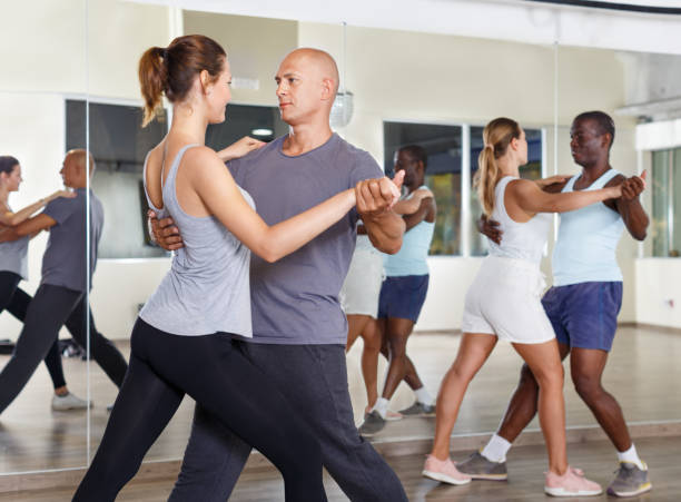istock People exercising waltz movements in pairs 1080375456