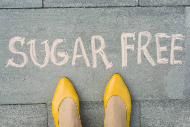 istock Female feet with text sugar free written on grey sidewalk 1080375700