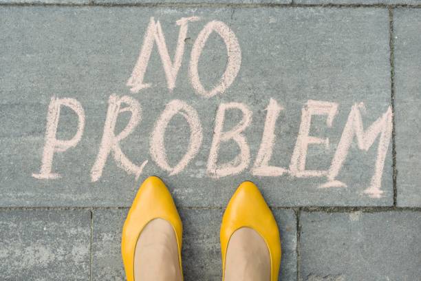 istock Female feet with text no problem written on grey sidewalk 1080377246