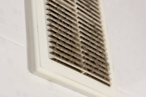 cleaning ventilation plastic dust. the filter is completely clogged with dust and dirt. dirty ventilation in the room. Disinfection service. stock photo