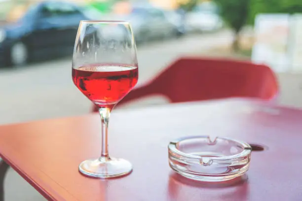 Glass of rose wine on the table in street cafe Vintage toning Selective focus Copy space