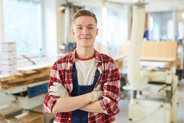 confident carpentry student in work gloves - trainee mechanic engineer student imagens e fotografias de stock