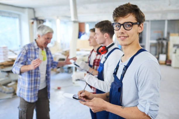 young worker at construction site - trainee mechanic engineer student imagens e fotografias de stock