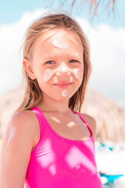 istock Father applying sun cream to daughter nose. 1080389012