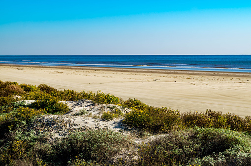 Sunny beach with golden sands blue sky and azure sea