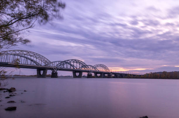 istock Large arched bridge. Wide bridge over the river. 1080395702
