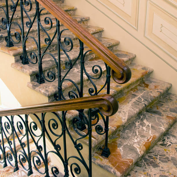 istock Marble staircase with wrought-iron railing and wooden handrail 1080395798