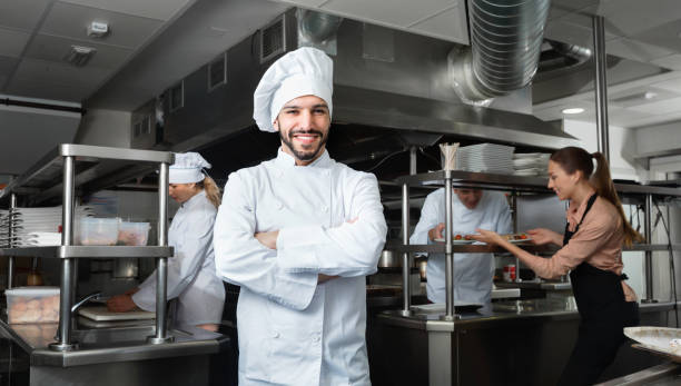 istock Portrait of satisfied smiling chef on restaurant kitchen 1080395992