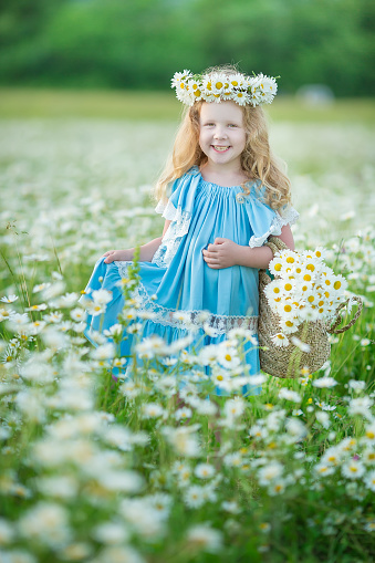 Outstanding beautiful girl lady on the daisy flowers field enjoying summer spring time with full soul of vacation.