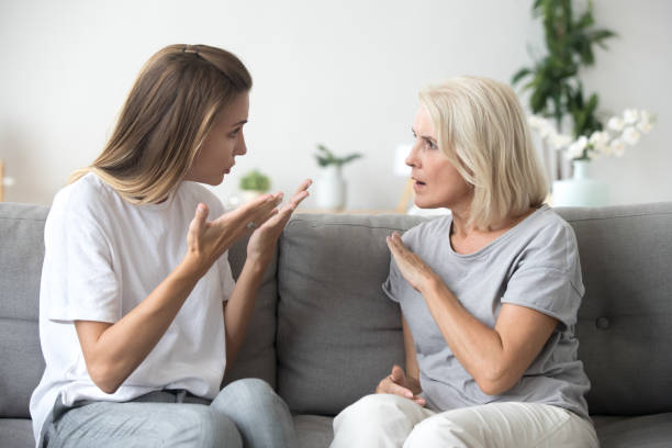 Angry young woman having disagreement with annoyed old mother Angry young woman has disagreement with annoyed old mother in law, grown daughter arguing fighting quarreling with senior elderly mom, different age generations bad relations family conflict concept fighting stock pictures, royalty-free photos & images