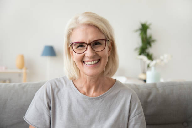 istock Smiling middle aged mature grey haired woman looking at camera 1080415396