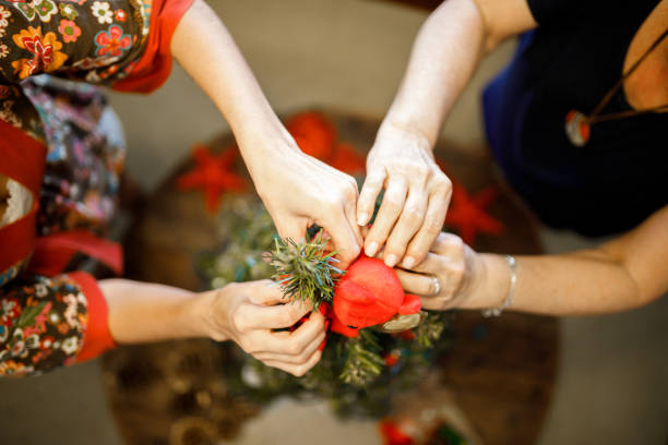 istock Mother and daughter decorating christmas tree 1080416230