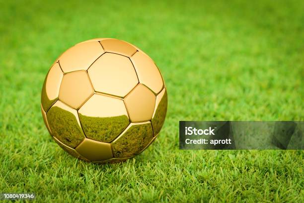 3d Rendering Golden Soccer Ball Football Lying On Grass In A Stadium Big Business In Sports Football Soccer Stock Photo - Download Image Now