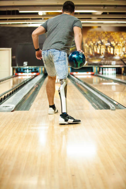 istock Man with prosthetic leg playing ten pin bowling 1080419734