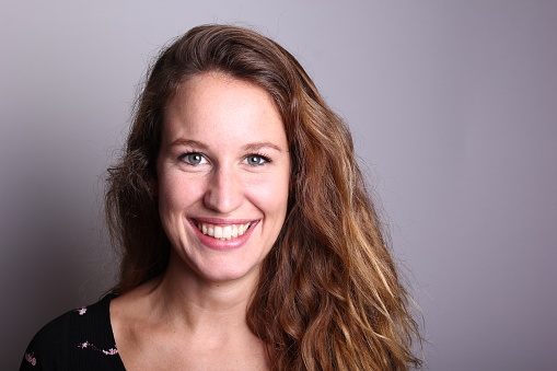 Beautiful caucasian woman in front of a grey background