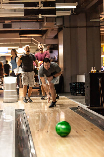 istock Men having fun in bowling alley 1080423456