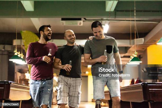 Friends Drinking Beer In Bowling Alley Stock Photo - Download Image Now - Adult, Adults Only, Alcohol - Drink