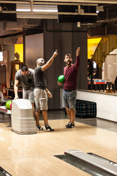 istock Bowling players looking at score 1080423684