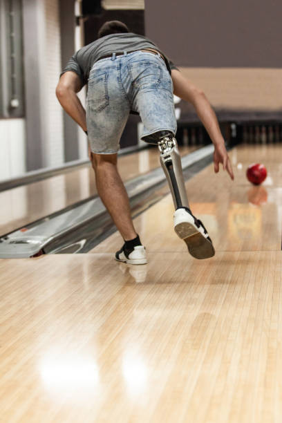 istock Man with artificial leg playing ten pin bowling 1080423838