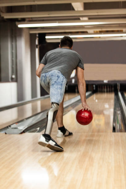 istock Man with artificial leg playing ten pin bowling 1080423846