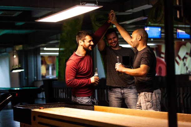 istock Friends giving each other high-five in the bar 1080424624