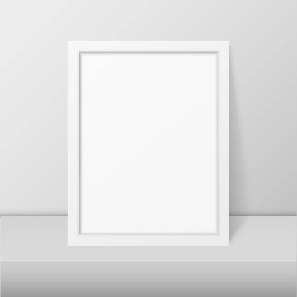 istock Vector 3d Realistic Modern Interior White Blank Vertical A4 Wooden Poster Picture Frame on Table or Shelf Closeup on White Wall, Mock-up. Empty Poster Frame Design Template for Mockup, Presentation 1080426088