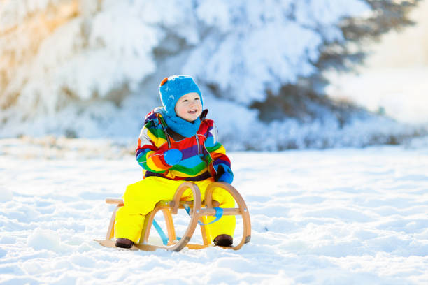 istock Boy on sleigh ride. Child sledding. Kid with sledge 1080427278