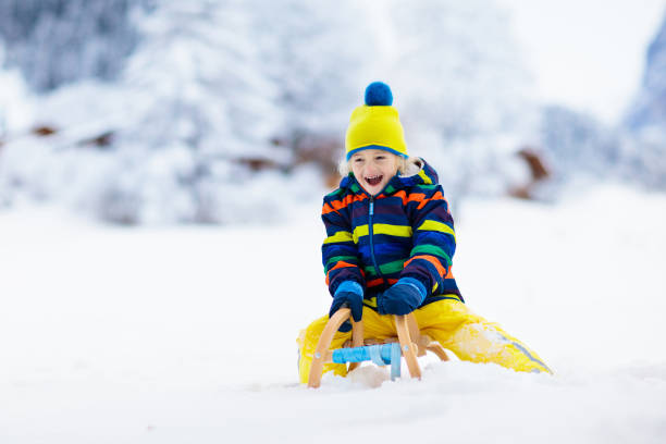 istock Boy on sled ride. Child sledding. Kid on sledge 1080427444