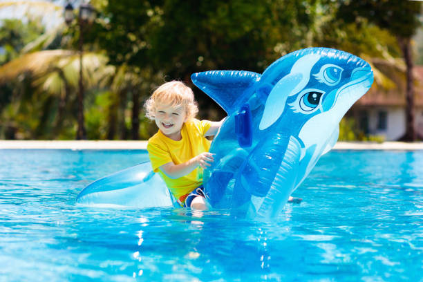 istock Child in swimming pool. Kid on inflatable float 1080427588