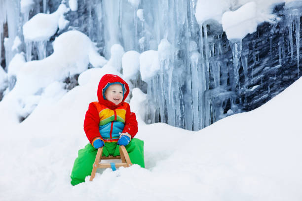 istock Boy on sled ride. Child sledding. Kid on sledge 1080429622