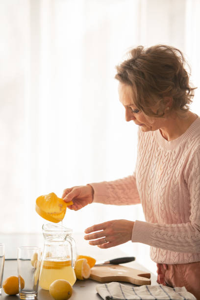 istock Woman pouring lemon juice 1080430320