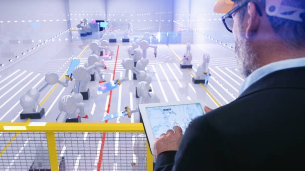 istock Smart automation industry robot in action welding metall while engineer uses his remote control table pc 1080432010