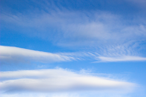 Beautiful sky with white clouds background. Light cumulus clouds in the blue sky. Wide photo.