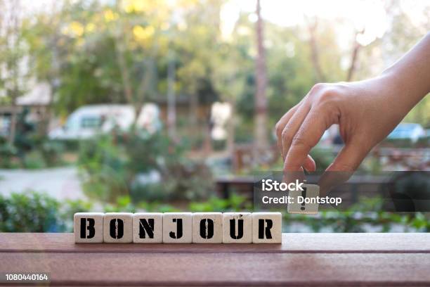 Bonjour Concept With Hand And Alphabet Blocks Stock Photo - Download Image Now - Alphabet, Block Shape, Business