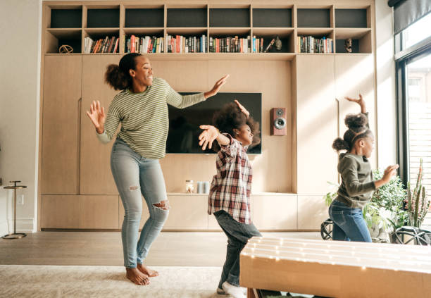 Mother and kids dancing Winter family fun dancing stock pictures, royalty-free photos & images
