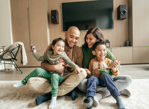 Happy family at home on winter holidays Happy family at home on winter holidays family at home stock pictures, royalty-free photos & images