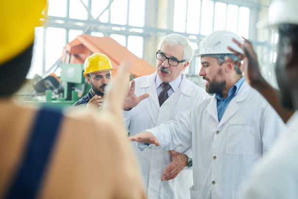 istock Senior Factory Managers Talking to Workers 1080450592