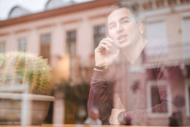 istock The happy man phone over the window 1080456702