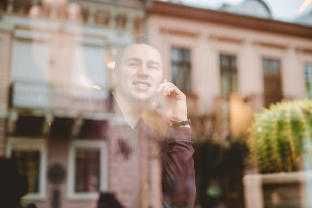 istock The happy man phone over the window 1080456726