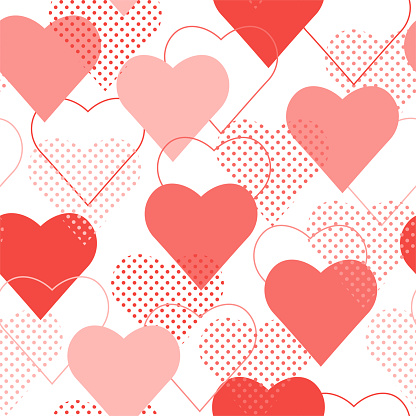 The seamless pattern with red and pink polka dot hearts. Vector.