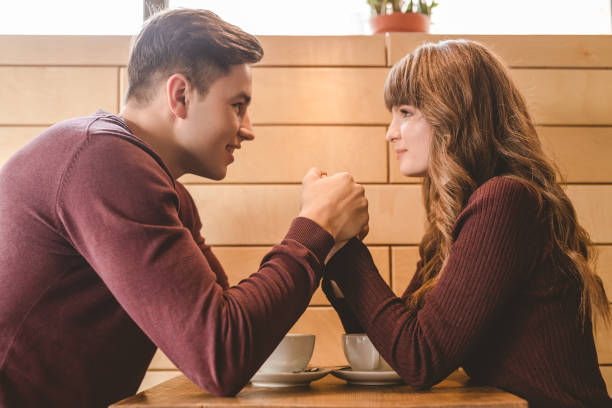 istock The attractive couple holding hands in the restaurant 1080457774