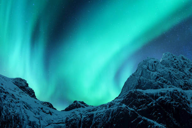 istock Aurora borealis above the snow covered mountain peak 1080458350