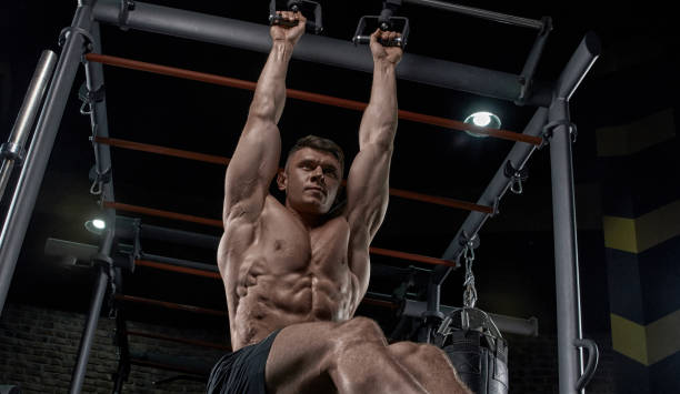 istock Muscular man working out in gym doing exercises. 1080461542