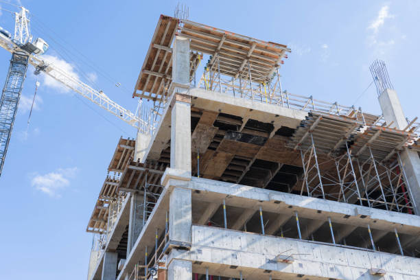 istock Construction Crane Next To New Building Construction Low Angle View Close Up 1080462028