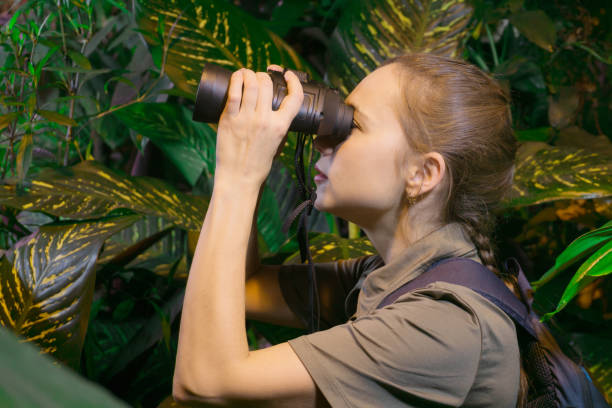 istock girl with binoculars in the jungle 1080466480