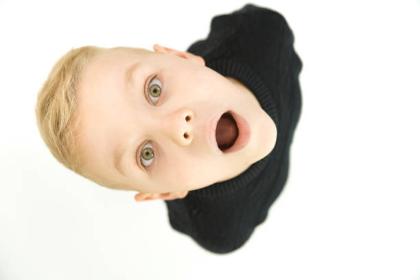 The shocked boy look to the camera. View from above