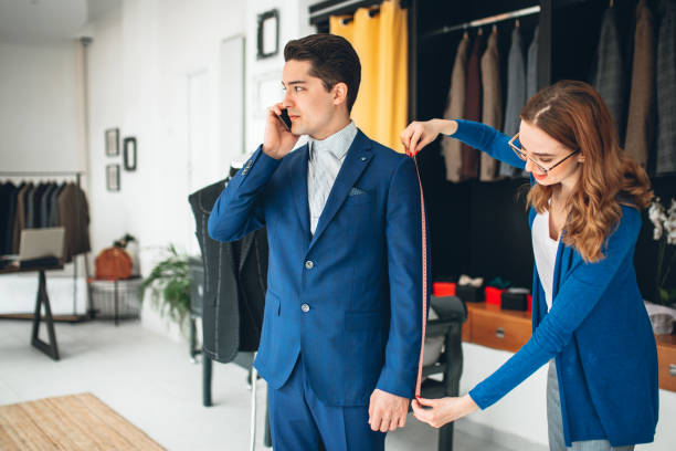 istock Tailor fitting suit to businessman in tailor shop 1080489160